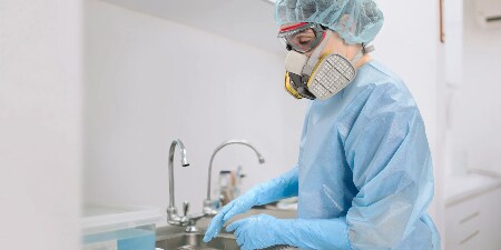 healthcare worker wearing PAPR with hood
